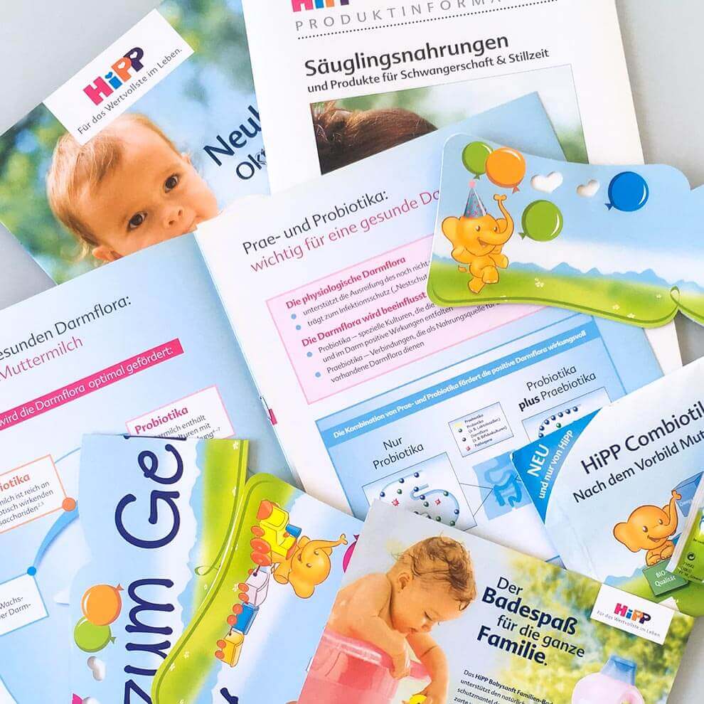 Various informational brochures and cards related to baby products, including a focus on probiotics and a new product for infants.